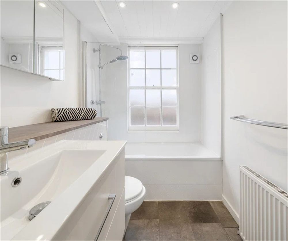 Angel flat bathroom after, same bath, toilet and radiator